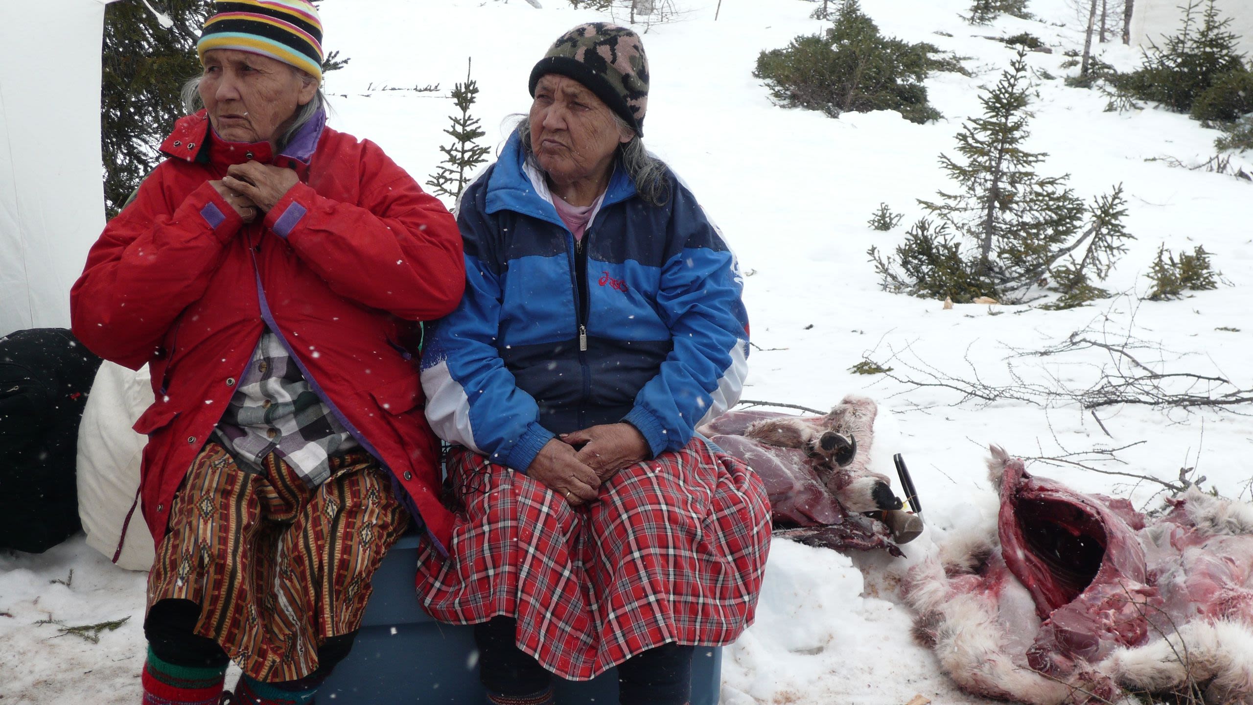 Two old Innu woman sitting outside